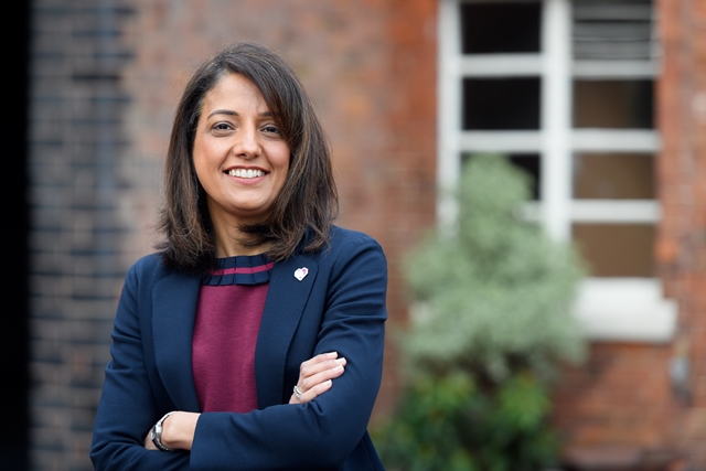 Bal standing and smiling outside of an office