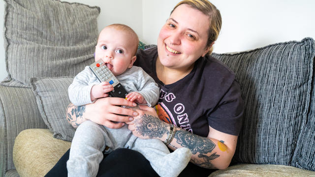 A Tenant Holding Her Baby In The Living Room