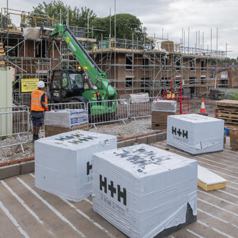 Collections of bricks with scaffolding in the background