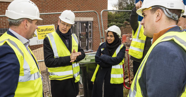 Glenn speaking with people while everyone is wearing high vis jackets and hard hats