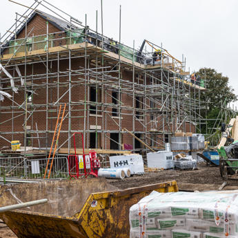 Workers focusing on the outside of a building with the help of scaffolding