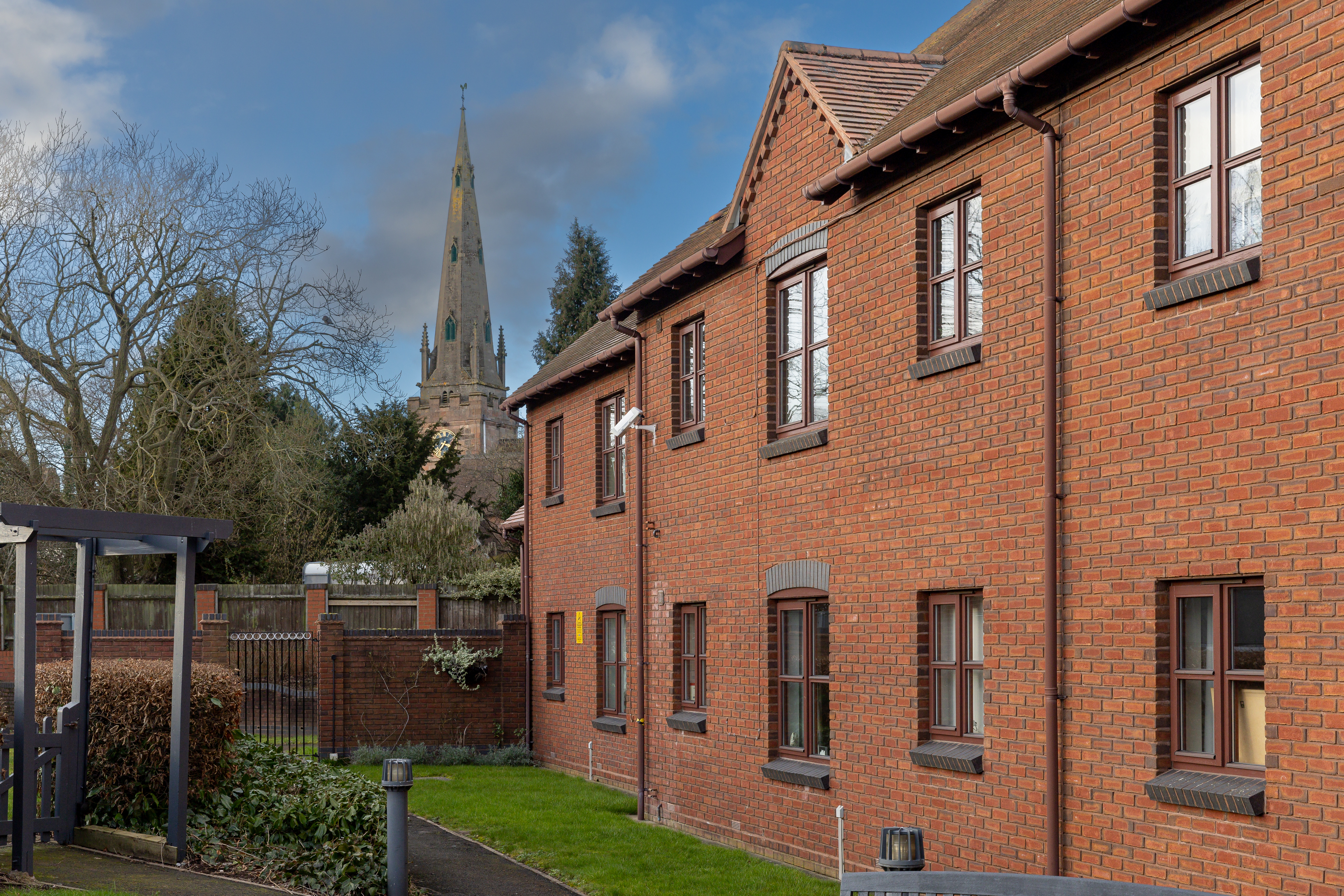 Arbourtree Court with a church in the background