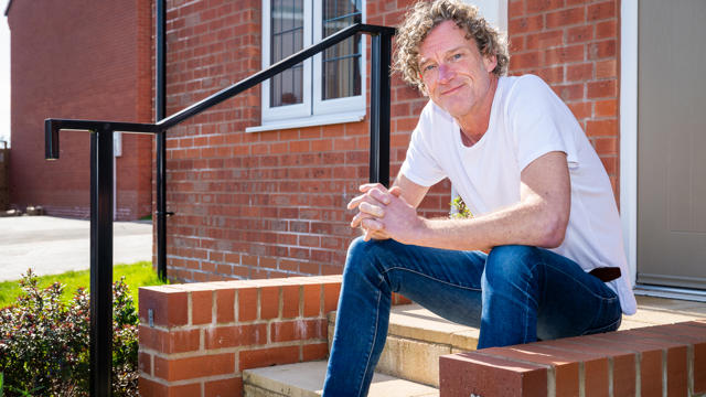 A Tenant Sitting On His Front Doorstep