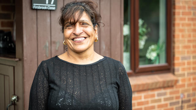 A Tenant Standing In Front Of Her Home