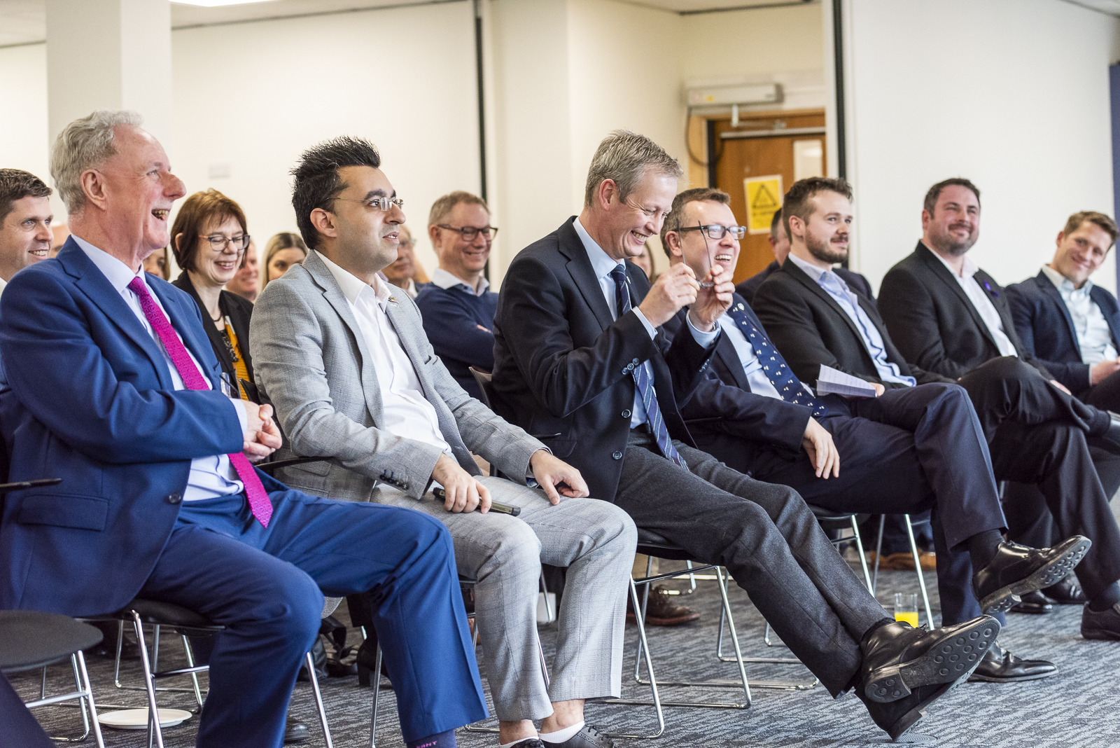 The crowd sat down laughing